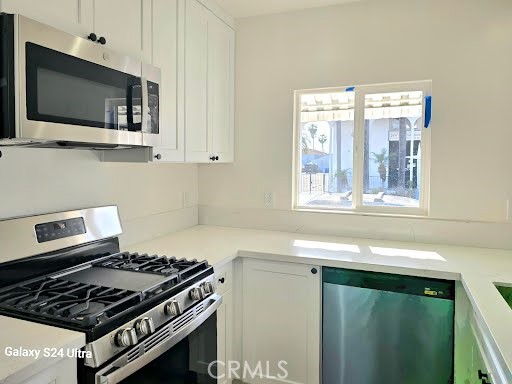 1350 East 94th Street Los Angeles, CA 90002 - Photo 8 of 15 a kitchen with granite countertop a stove and a sink