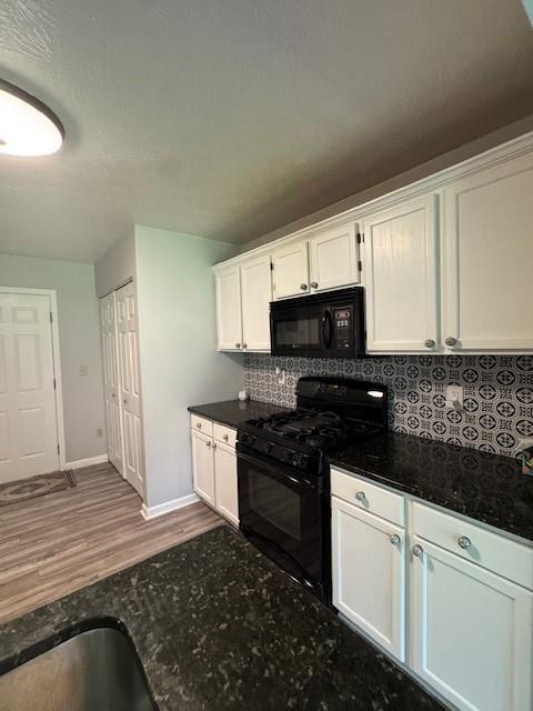 1003 Rural Ridge Drive Cheswick, PA 15024 - Photo 10 of 30 a kitchen with granite countertop white cabinets and black appliances