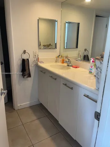 a bathroom with a sink vanity and mirror