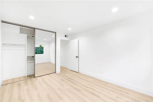 a view of a livingroom with wooden floor and white doors