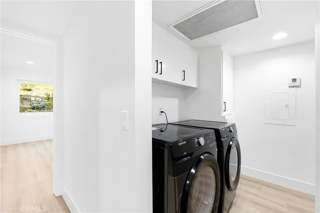 a view of a storage and utility room with washer and dryer