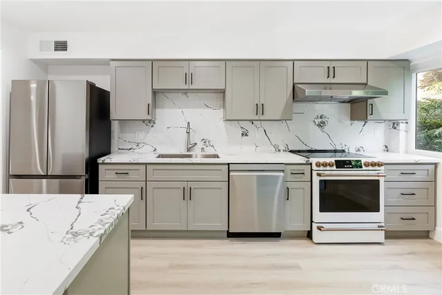 a kitchen with cabinets appliances and a counter space