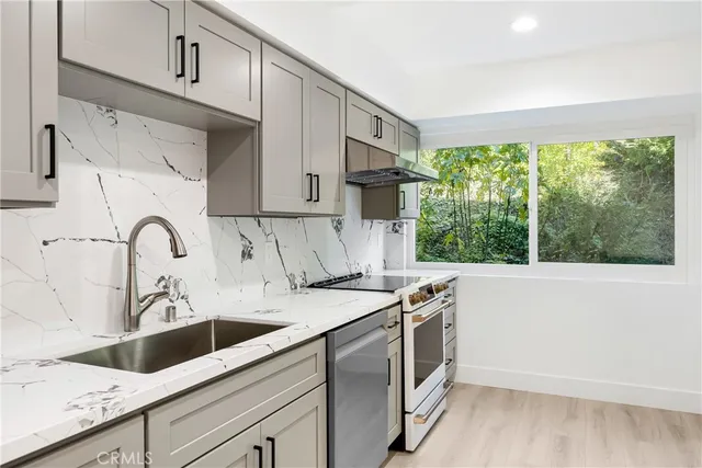 a view of a kitchen with sink and cabinets