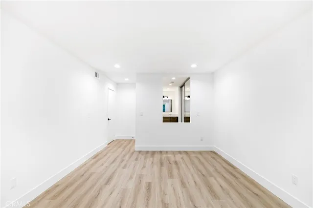 a view of a room with wooden floor and windows
