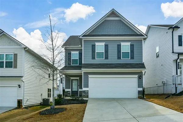 a front view of a house with a yard