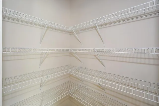 a view of a kitchen with wooden floor and a window