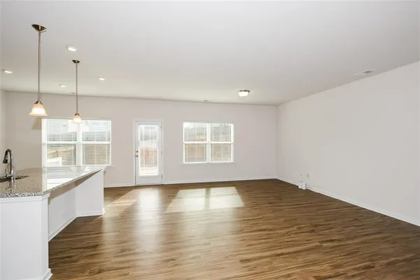 a view of kitchen with wooden floor and electronic appliances