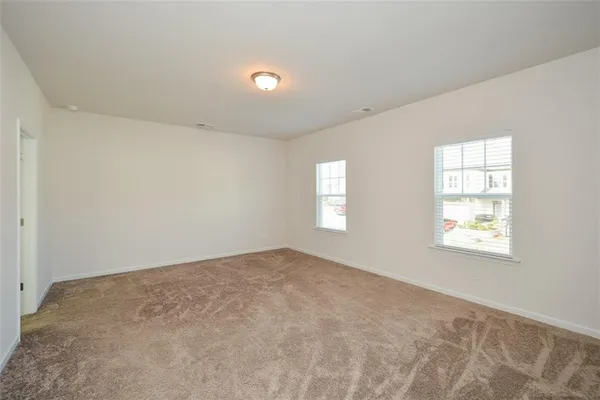 an empty room with windows and closet