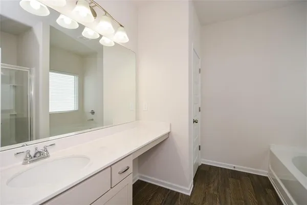 a bathroom with a bathtub and a shower