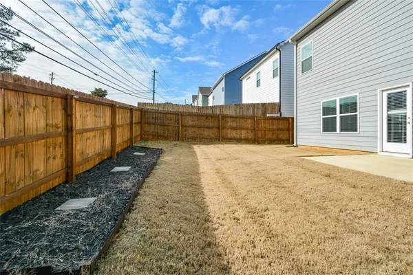 a view of a house with a backyard