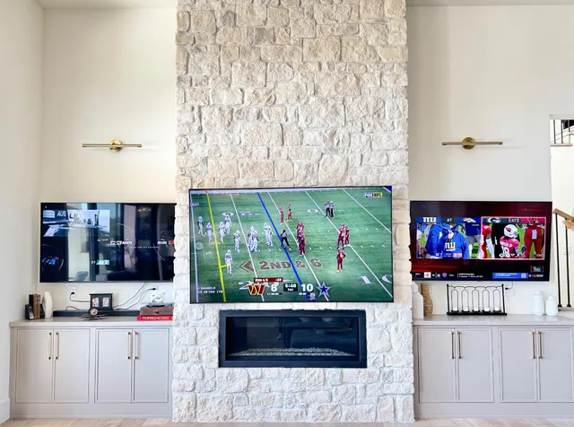 a living room with granite countertop furniture a fireplace and flat screen tv