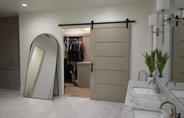 a living room with furniture and paintings on the wall