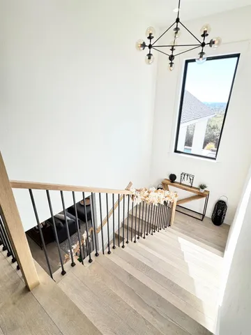 a bedroom with a bed and a flat tv screen on dresser
