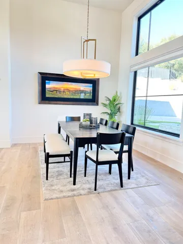 a kitchen with a sink stove and wooden floor
