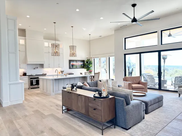 a living room with furniture and large windows