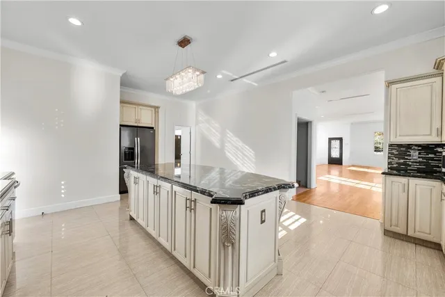 a open kitchen with white cabinets and stainless steel appliances
