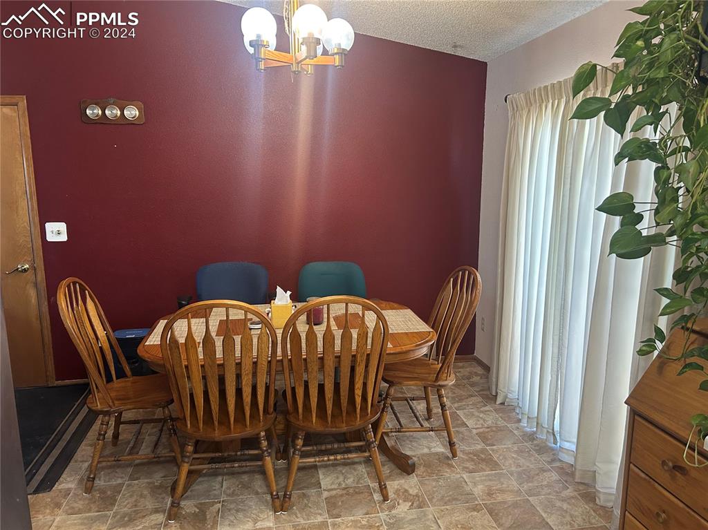 15840 Teak Place Elbert, CO 80106 - Photo 16 of 32 a view of a dining room with furniture and chandelier