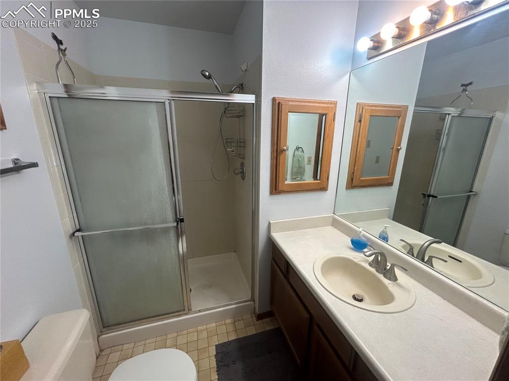 15840 Teak Place Elbert, CO 80106 - Photo 24 of 32 a bathroom with a sink toilet and shower