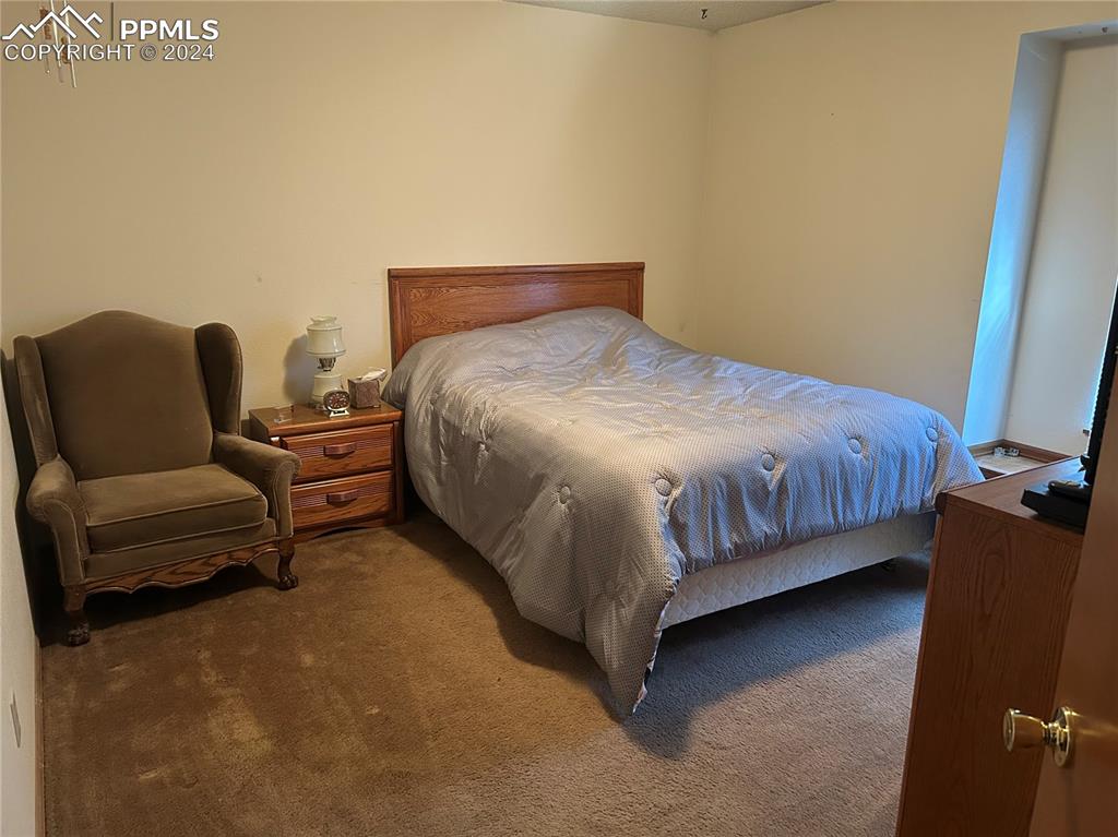 15840 Teak Place Elbert, CO 80106 - Photo 25 of 32 a bedroom with a bed and a couch