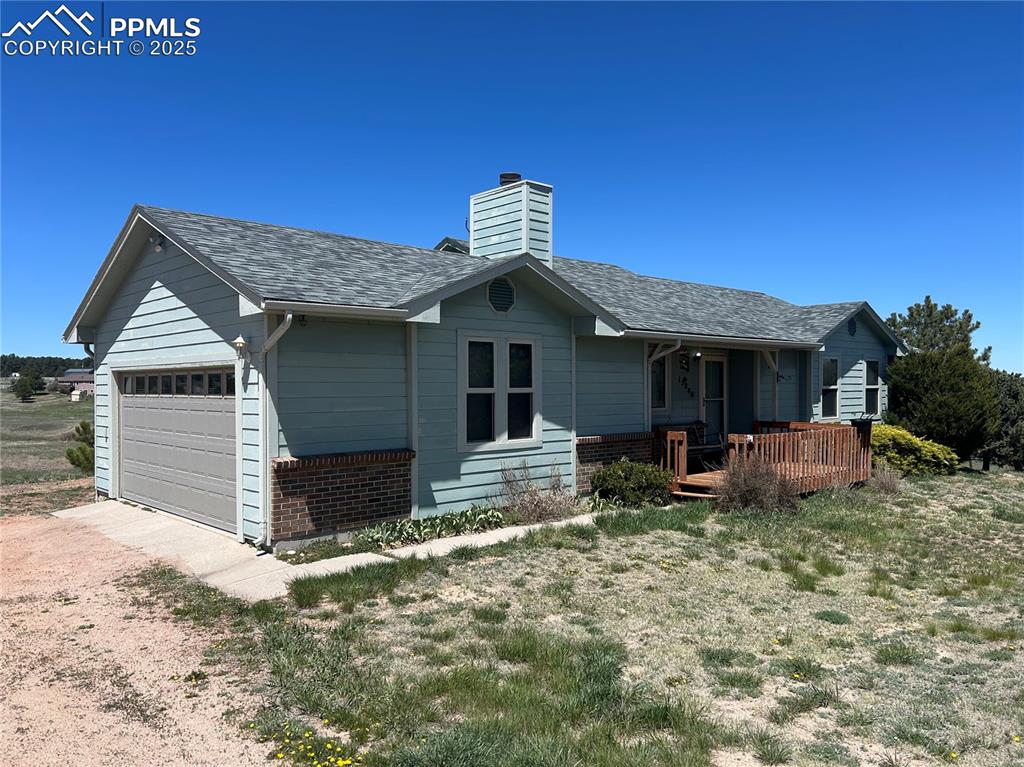15840 Teak Place Elbert, CO 80106 - Photo 6 of 32 a front view of a house with yard and seating space