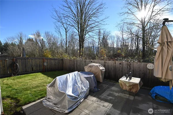 a view of a backyard with furniture and a fire pit