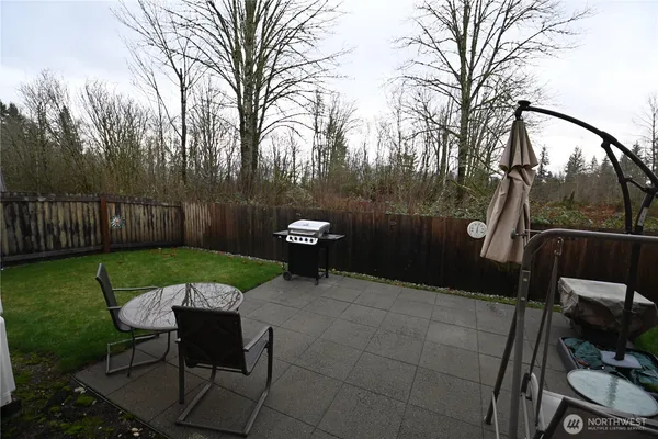 a view of a chairs in backyard of house