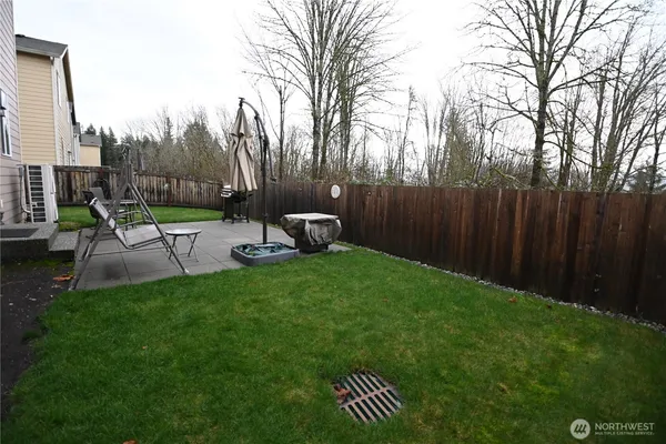 a view of a backyard with sitting area