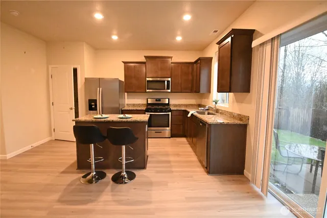 a kitchen with a sink appliances and cabinets