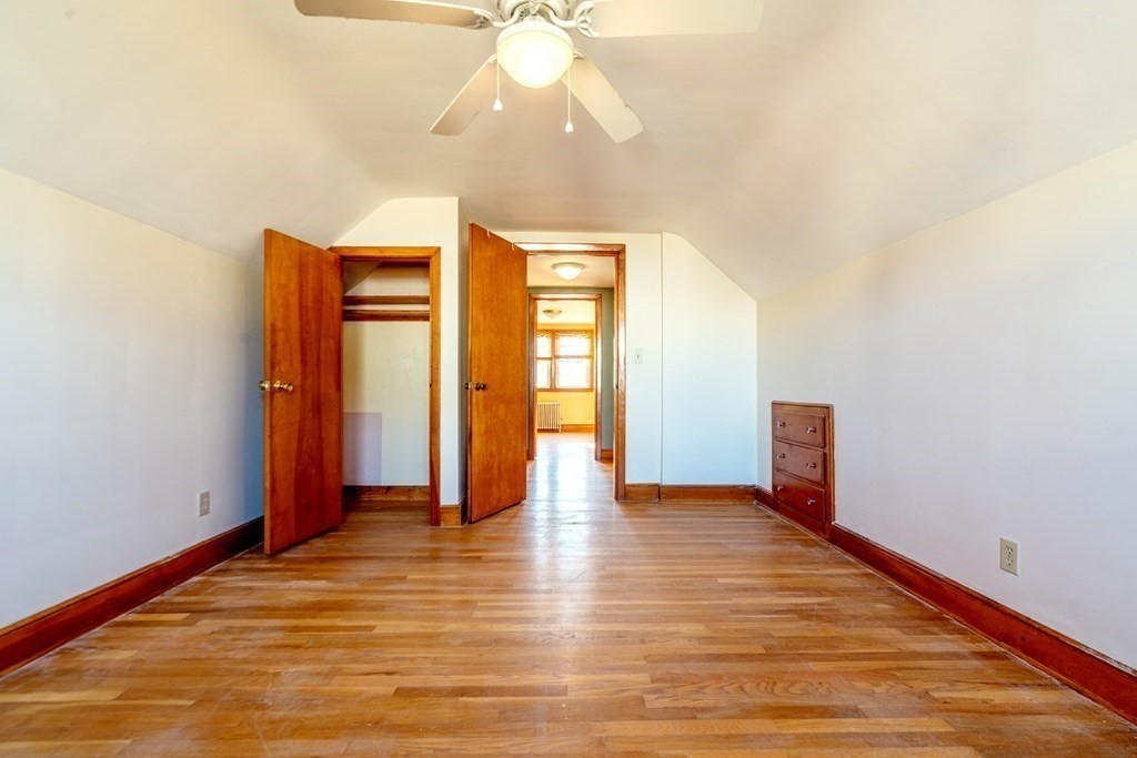 95 Rome Avenue Providence, RI 02908 - Photo 11 of 15 a view of an empty room with window and wooden floor
