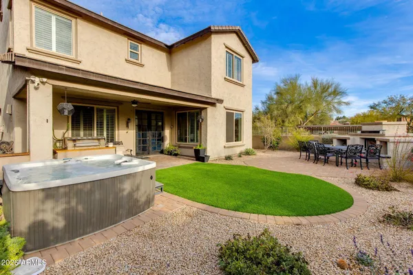 a view of a white house with a swimming pool and a garden