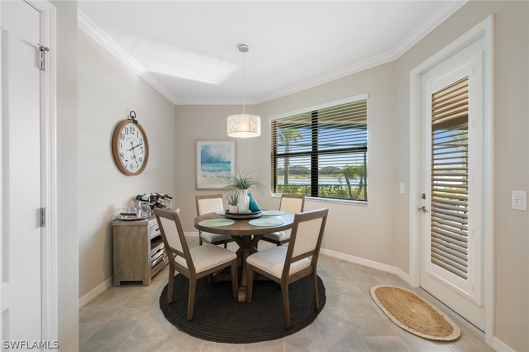 19729 Beechcrest Place Estero, FL 33928 - Photo 13 of 45 a dining room with furniture and a large window