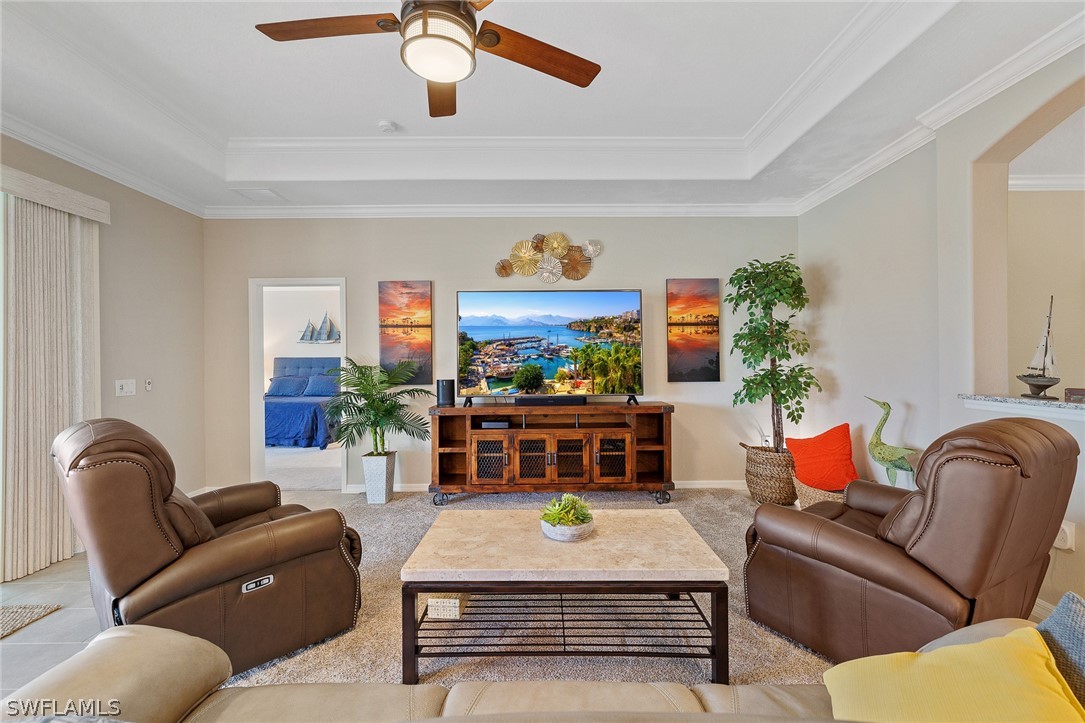 19729 Beechcrest Place Estero, FL 33928 - Photo 14 of 45 a living room with furniture a rug and a chandelier
