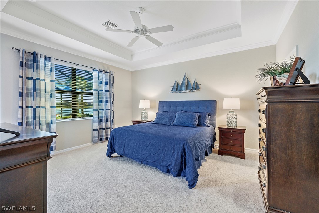 19729 Beechcrest Place Estero, FL 33928 - Photo 16 of 45 a spacious bedroom with a bed dresser and a large window