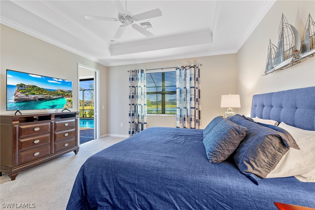 19729 Beechcrest Place Estero, FL 33928 - Photo 17 of 45 a bedroom with a bed and a flat screen tv