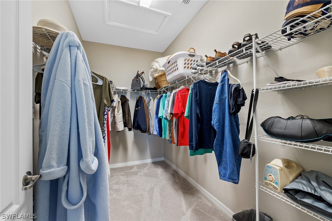 19729 Beechcrest Place Estero, FL 33928 - Photo 18 of 45 a view of walk in closet with clothes and shoes