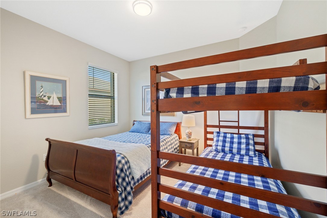 19729 Beechcrest Place Estero, FL 33928 - Photo 22 of 45 a bedroom with a bed and a large window