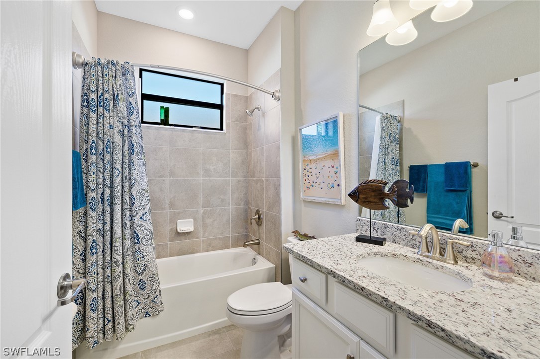 19729 Beechcrest Place Estero, FL 33928 - Photo 24 of 45 a bathroom with a granite countertop sink toilet and shower