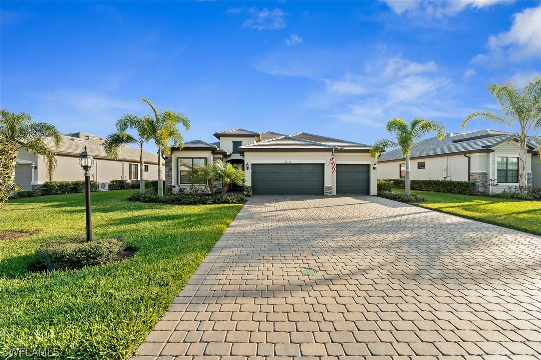 19729 Beechcrest Place Estero, FL 33928 - Photo 4 of 45 a view of house with garden and tall tress