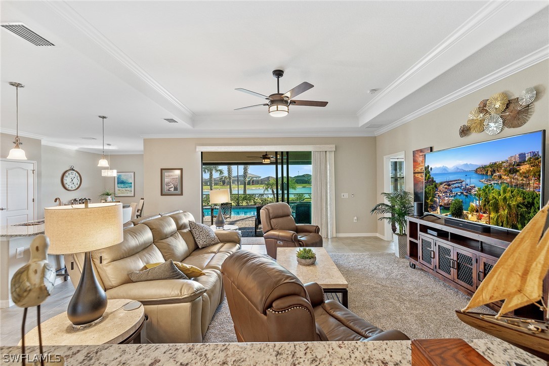 19729 Beechcrest Place Estero, FL 33928 - Photo 7 of 45 a living room with furniture a flat screen tv and a large window