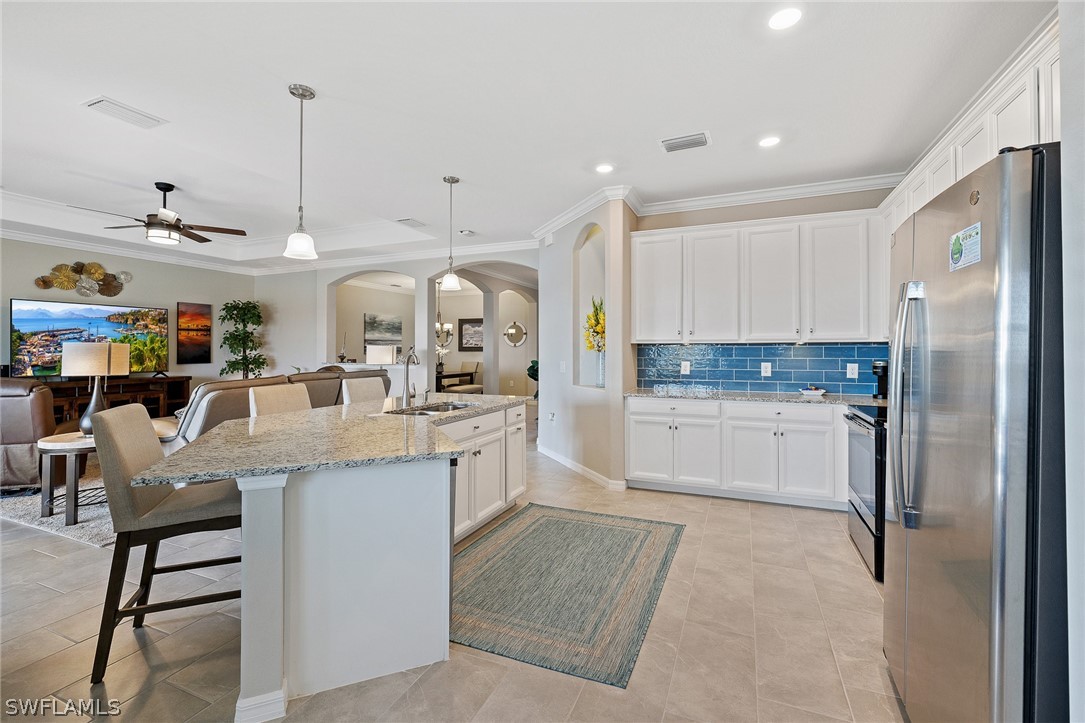 19729 Beechcrest Place Estero, FL 33928 - Photo 10 of 45 a kitchen with white cabinets and stainless steel appliances