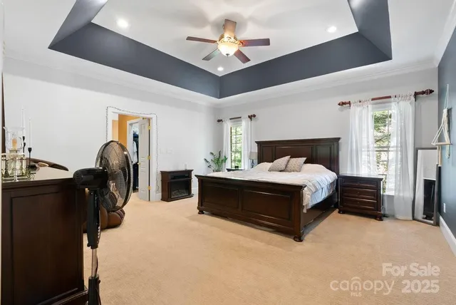 a bed room with a bed and a chandelier