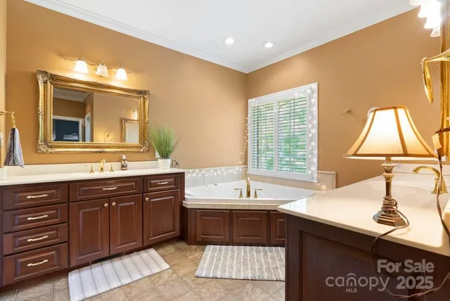 a spacious bathroom with a sink double vanity and a mirror