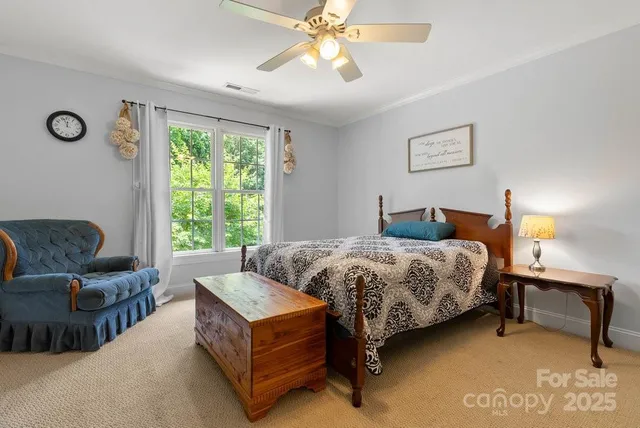 a bedroom with a bed couch and window