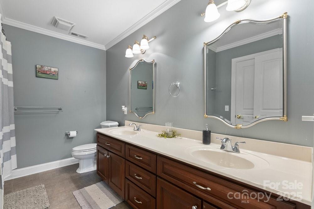 134 Brightmore Circle Rutherfordton, NC 28139 - Photo 18 of 40 a bathroom with a double vanity sink mirror and toilet