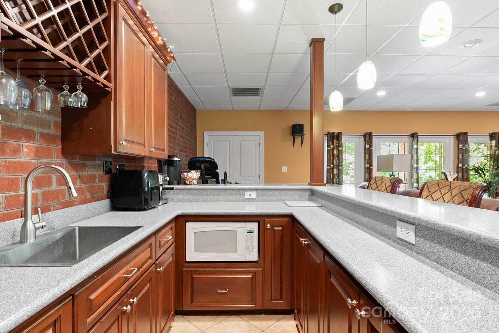 134 Brightmore Circle Rutherfordton, NC 28139 - Photo 24 of 40 a kitchen with stainless steel appliances granite countertop a sink a stove and a wooden cabinets