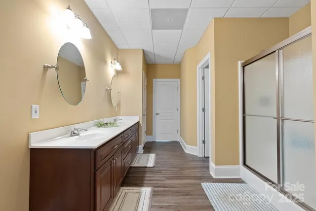 a bathroom with a double vanity sink and a mirror