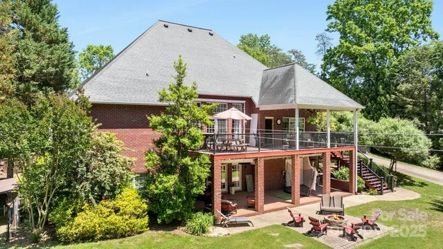 an aerial view of a house with swimming pool next to a yard