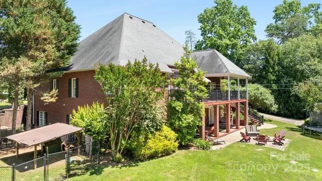 an aerial view of a house with yard and outdoor seating