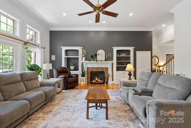 a living room with furniture fireplace and window