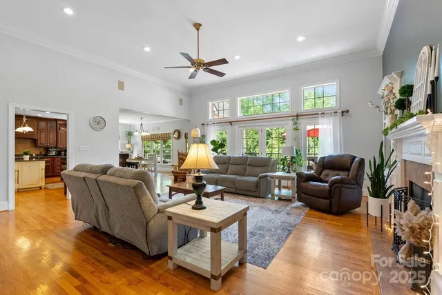 a living room with fireplace furniture and a large window